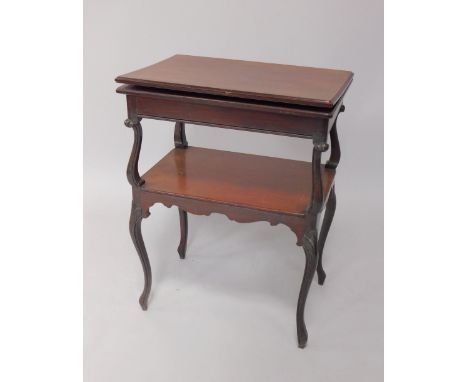 A Victorian mahogany fold over card table, the top raised on cabriole supports above an under tier with shaped skirt over fou