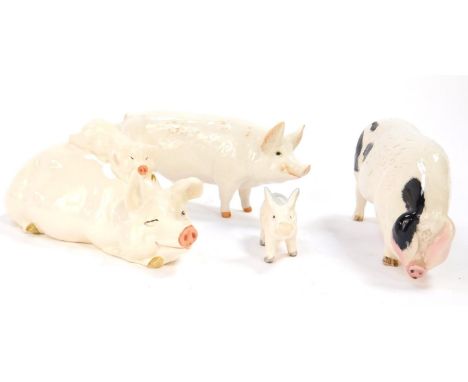 A Beswick pottery figure of a recumbent pig with a piglet on it's back, further pig Champion Wall Boy, a piglet and a Royal D