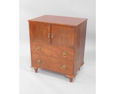 A George III mahogany commode, converted to a pot cupboard, with two doors over a large dummy drawer, raised on tapering feet