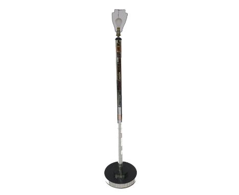 A mirrored glass standard lamp, raised on a stepped circular base, 173cm high including lamp shade holder.