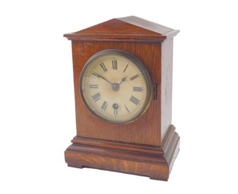 A Victorian oak cased mantel clock of architectural form, enamel dial bearing Roman numerals, thirty hour movement, 16.5cm x 