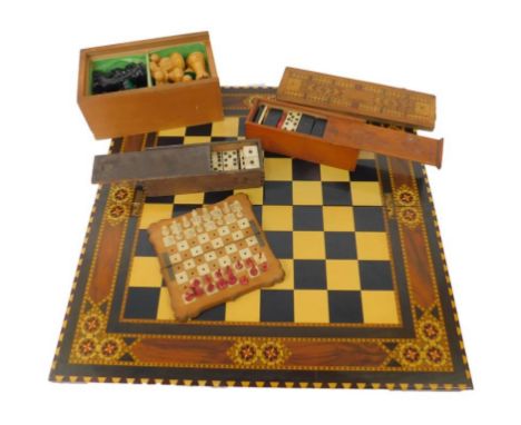 A Victorian white and red stained ivory travelling chess set, on a folding serpentine wooden and ivory board, a Staunton ches