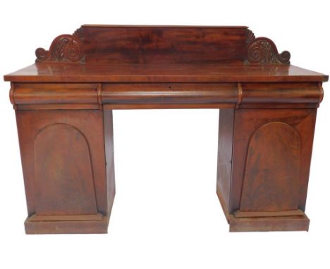 A Victorian mahogany sideboard, the back with acanthus carved ends, over three cushion drawers, above a pair of pedestals, on