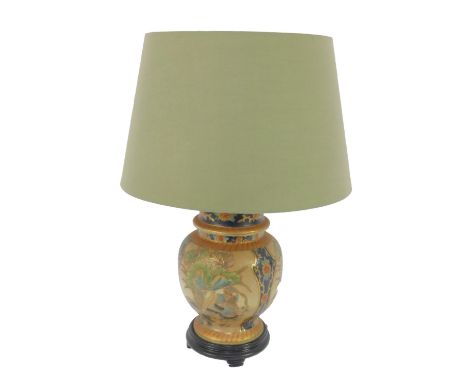 A Satsuma style pottery table lamp, of vase and cover form, raised on an integral wooden base, with shade, 57.5cm high.