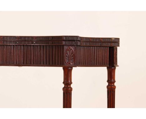 A George III mahogany card table in the manner of Ince and Mayhew,of serpentine outline with reeded and anthemion decoration,