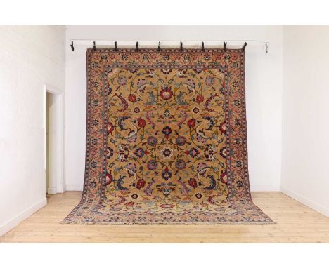 A Persian wool carpet attributed to the Benlian workshops,early 20th century, Tabriz, the pale field woven in vibrant colours