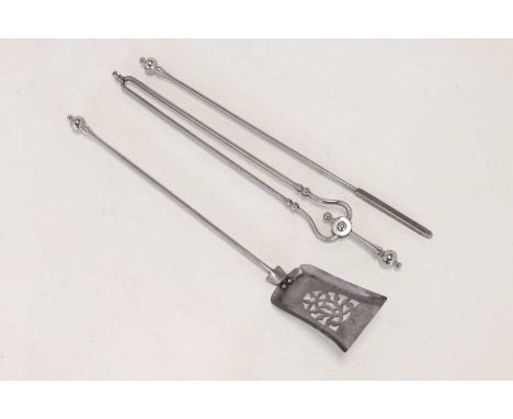 A set of polished steel fire tools,19th century, comprising of poker, tongs and shovel, the shovel with a pierced bowl,78cm l