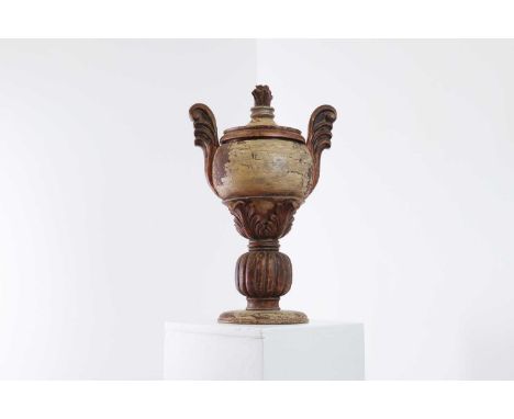 A turned wooden and gesso urn,19th century, French, with scroll-form handles above acanthus leaves in relief, and a gadrooned