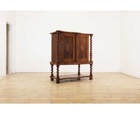 An oyster-veneered laburnum, maple and walnut collector's cabinet,19th century, the serpentine top above a pair of inlaid doo