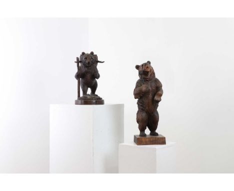 Two Black Forest carved wood bears,late 19th/early 20th century, Swiss, the first standing holding a club, the second, a pipe