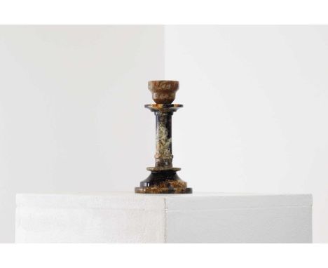 A Derbyshire Blue John candlestick,19th century, with a knopped stem and stepped circular base,8.5cm diameter17cm highProvena
