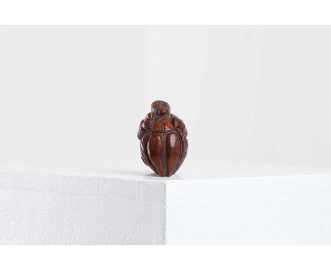 A coquilla nut figural snuff box,early 19th century, Northern European, in the form of a portly gentleman holding a goblet an