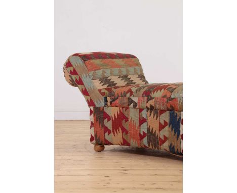 A kilim-upholstered Ottoman daybed, 20th century, with interior storage, on bun feet,170cm wide60cm deep70cm high