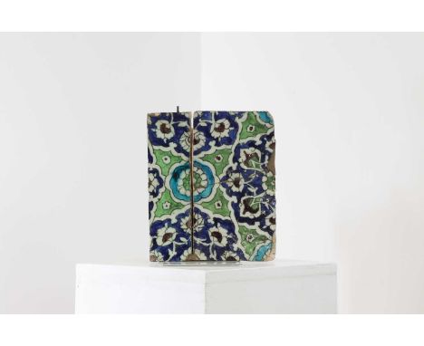 A Persian wall tile,purportedly from the Alhambra, Grenada, Spain, painted in underglaze green and blue with an Iznik-style p