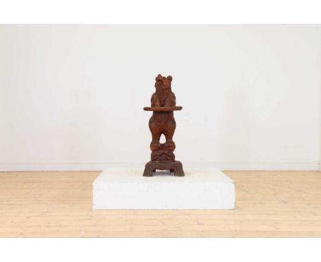 A Black Forest carved wood stick stand,late 19th/early 20th century, Swiss, in the form of a standing bear with glass eyes, o