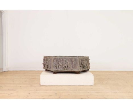 A large octagonal lead planter,20th century, English, the sides decorated in relief with cavorting cherubs,112cm wide97cm dee