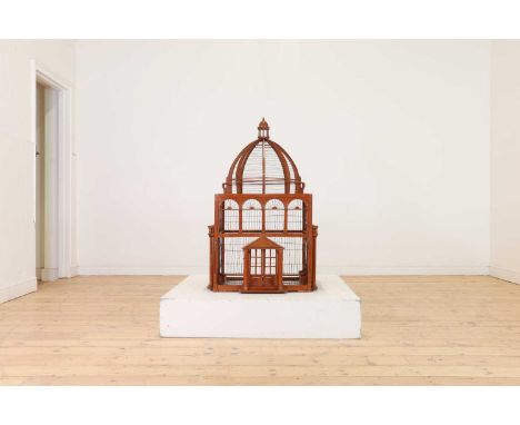 A wooden birdcage,20th century, probably French, of architectural form,56cm wide56cm deep105cm high