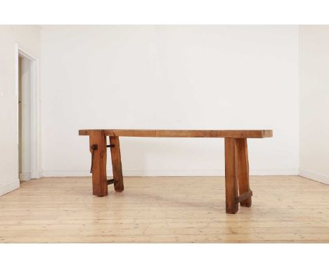 A rustic elm workbench console table, early 20th century, French, the thick top raised on square supports, one set with an ir