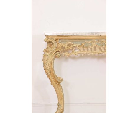 A carved and painted pine console table,19th century, Italian, the rectangular marble top above a foliate carved and pierced 