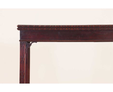 A George III mahogany card table,the fold-over top with a carved edge, enclosing an interior with original baize lining, over