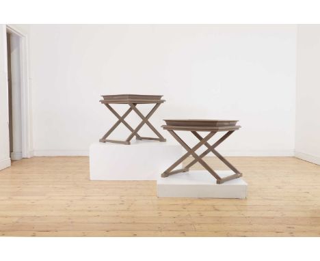 A pair of painted side tables by Blanc d'Ivoire,of recent manufacture, French, each rectangular tray top on an 'X' framed sta