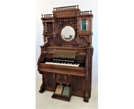 Harmonium made by Thomas Organ &amp; Piano Co. Woodstock Ontario, Canada with panelled base supported on leaf carved stiles, 