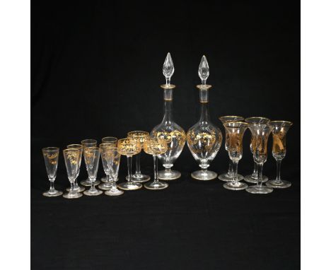 A pair of slender teardrop shaped 19th century continental liqueur or cordial decanters with gilt enamel highlights and scrol