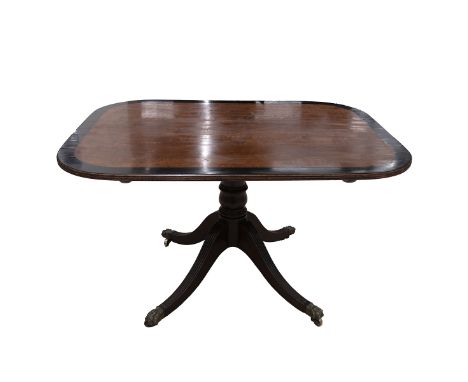 Regency mahogany tilt top breakfast table c1820s. Rectangular top with wide ebony band, single baluster base with four sweepi