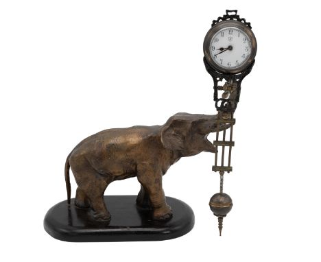 Mystery Clock by Junghans, in the form of a cast metal elephant, its raised trunk supporting the clock with enamelled dial, A