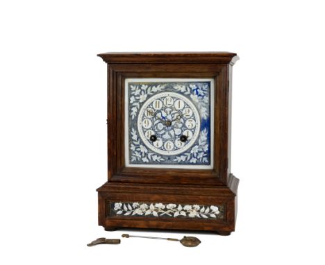 In the manner of Lewis Foreman Day, a late 19th Century oak cased two train, eight day mantle clock. A glazed hinged door ope