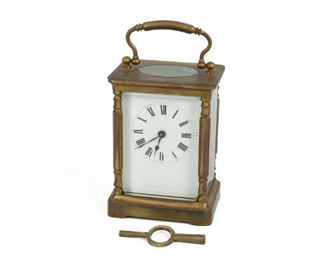 Early 20th century brass cased carriage clock with swing handle, inscribed to the top 18/6/18, with enamel dial and Roman num