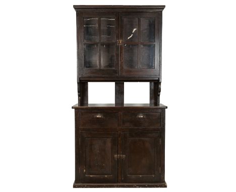 Pine kitchen dresser, c1900. Dark stained finish, two drawers to base with long cupboard underneath. Glazed doors to top with