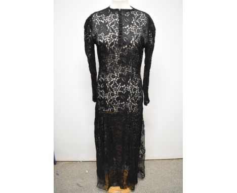 A 1930s bias cut lace evening dress, having button down front, round collar and long sleeves with button cuff,overall good co