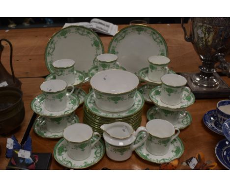 A selection of early 20th century tea service, having white ground with green swag transfer design and gilt heightening.
