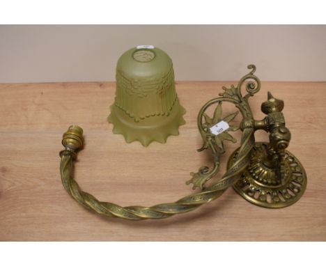 A vintage brass adjustable wall light and glass shade