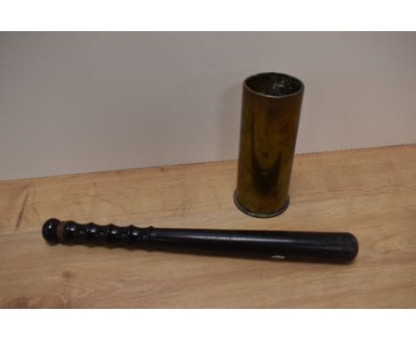 A vintage truncheon and brass mortar shell