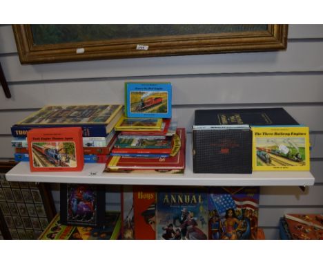 A shelf of vintage and modern Thomas The Tank Engine books.