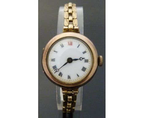 9ct gold ladies wristwatch with Roman numerals, blued Breguet hands, gilt minute markers and white enamel dial, on 9ct gold b