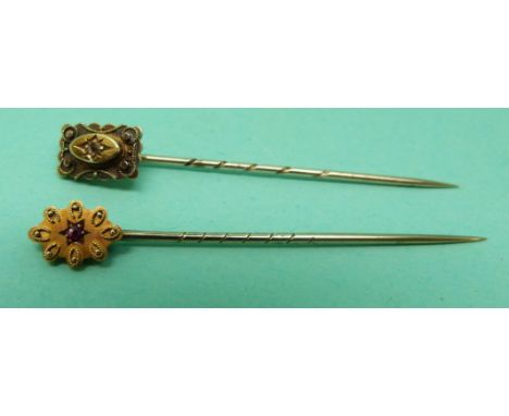 Two 15ct gold stick pins one set with a diamond, the other a ruby 