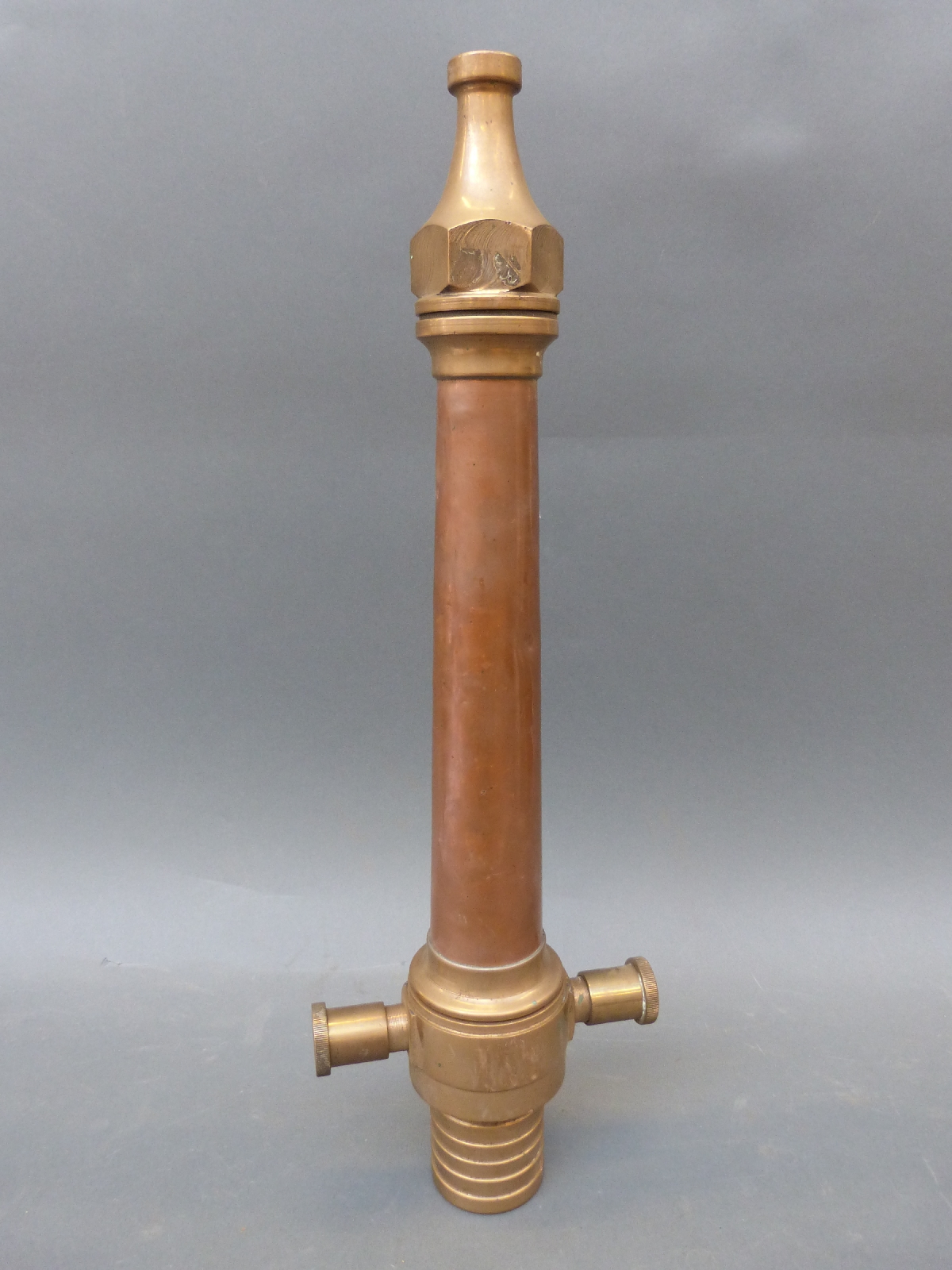 Two vintage copper and brass fire hose nozzles