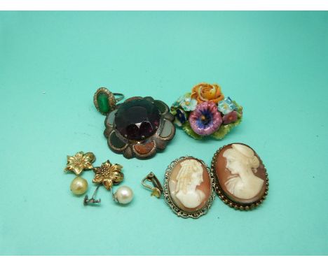 A silver brooch set with a large amethyst surrounded by various sections of agate marked Scotland, two cameo brooches, a pear