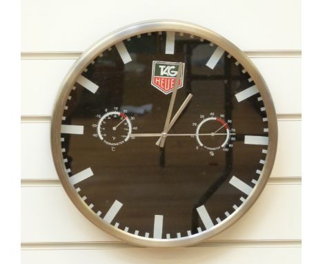 Tag Heuer advertising wall clock with thermometer and hygrometer to dial, black face and aluminium case, 35cm in diameter. 