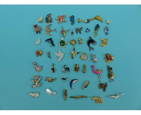 A collection of animal, fish and bird related brooches to include Monet, Ambassador, ceramic dolphin, gem set elephant, gem s