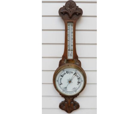 An early 20thC aneroid wall barometer and thermometer combination, in carved oak case, with brass plaque inscribed Presented 