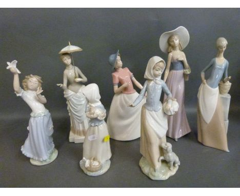 A collection of Nao figurines including girls with baskets, puppy, flowers, dove etc