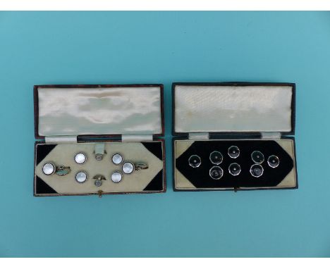 A cased set of cufflinks and studs with mother of pearl edged with onyx decoration, together with a further set with onyx cen
