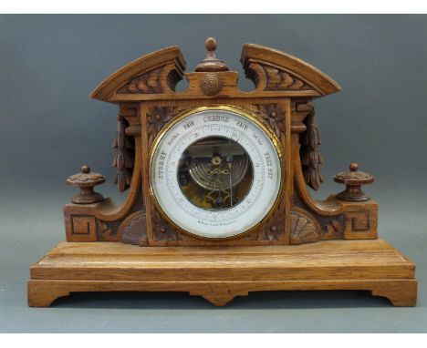 W. Aronsberg & Co Manchester holosteric free standing barometer, in carved oak case with white enamelled chapter ring dial