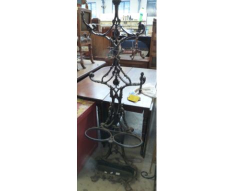 A cast iron hat/coat stand with umbrella/stick stand and drip tray, height 153cm