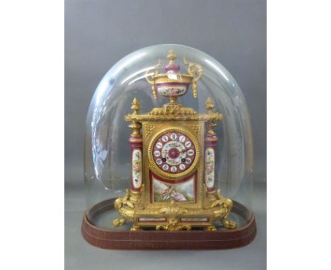 A mid to late 19thC French clock in gilt metal with painted Sevres style panels, the two train movement by R & C Paris and Lo