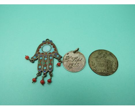 A white metal Nepalese/ Tibetan pendant in the form of the hand of Fatima set with enamel and coral beads together with two l